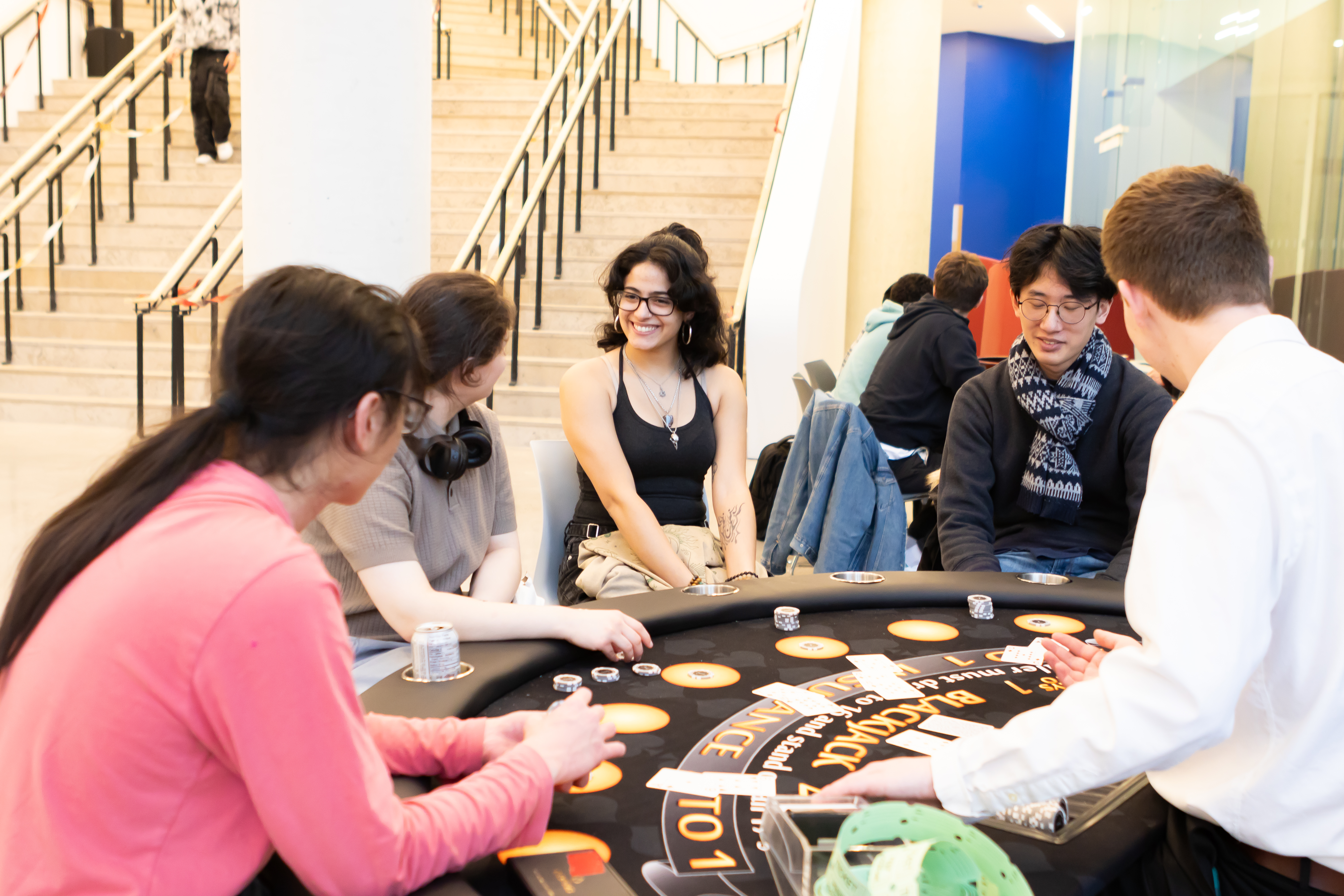 People sitting around table playing games.