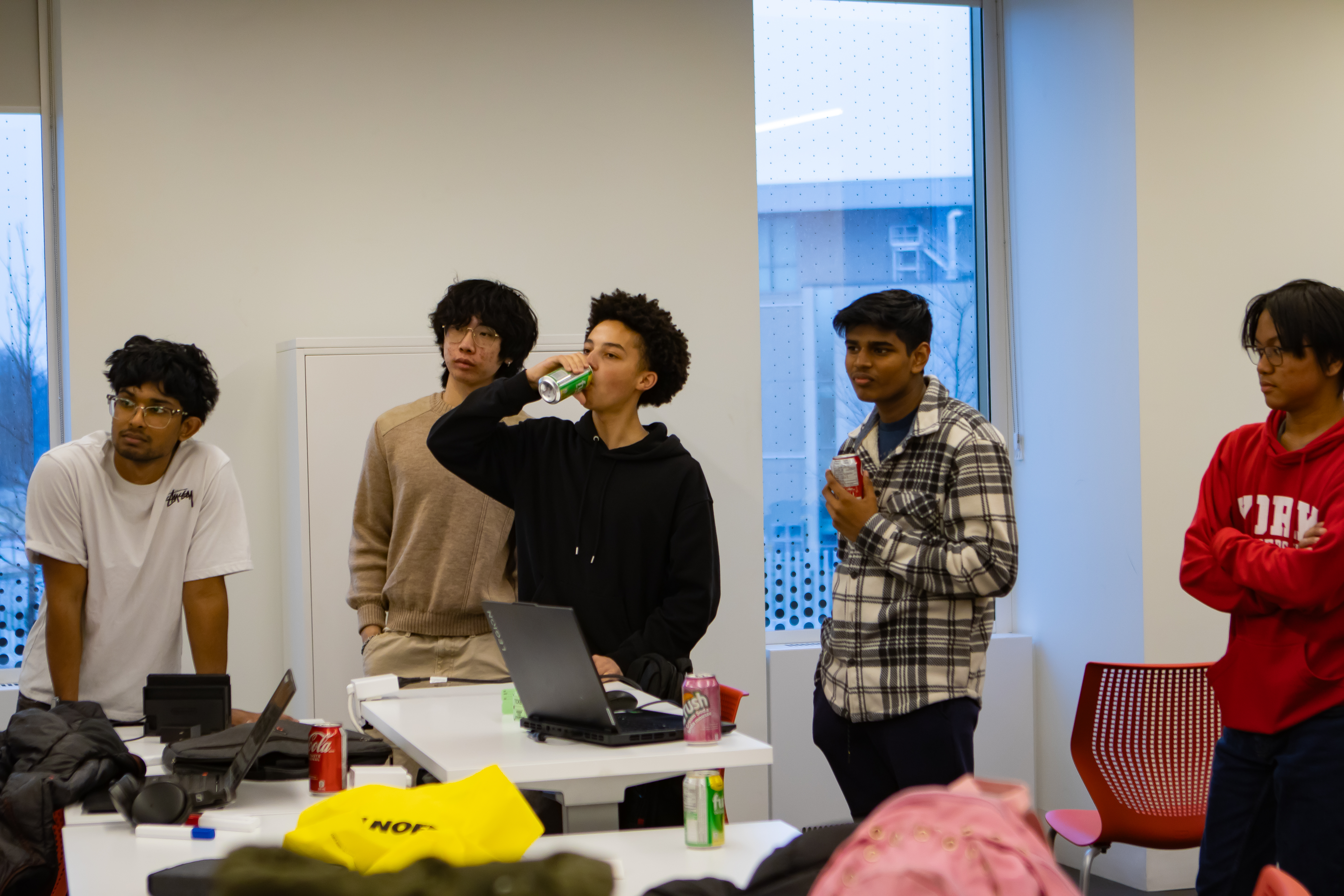 Group of people standing and watching a screen